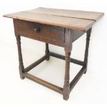 An 18th century oak side table: the overhanging moulded top above a single full-width drawer and