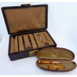 An early 20th century faux crocodile leather stud box containing three yellow meal studs headed with