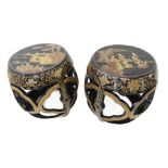 A pair of Chinese black lacquer and gilded drum-shaped stools: the tops individually decorated