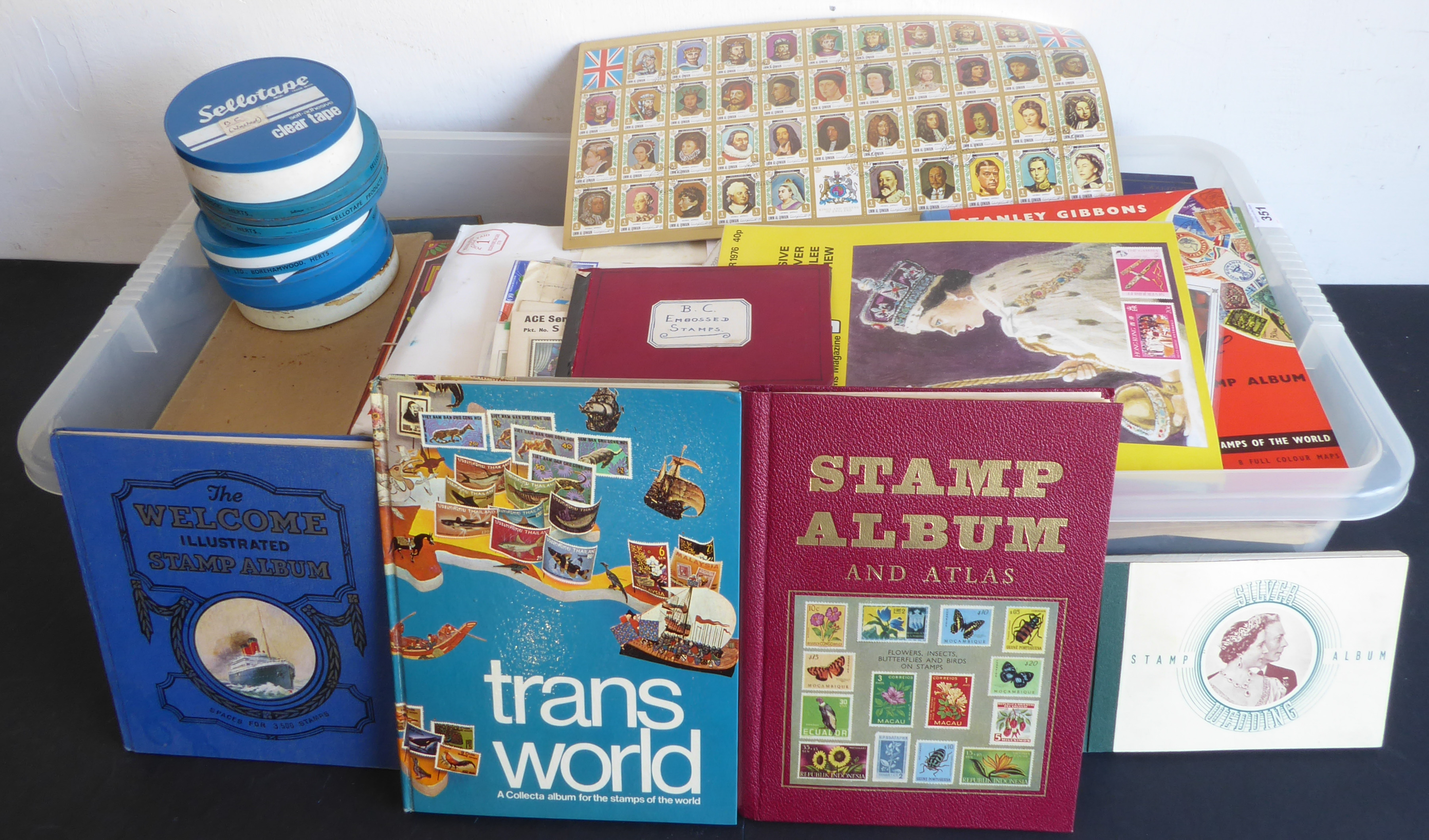 An assortment of world stamps in tins, boxes and albums