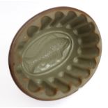 An oval 19th century salt-glazed jelly mould, the base impressed with a fish design (thumbnail-sized