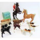 Eleven pieces by Beswick: huntsman on a rearing horse (868); three foxhounds (one boxed), palomino