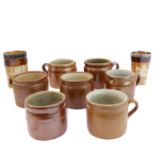 Seven salt-glazed stoneware ale tankards each with ribbed strap handles, together with a Doulton