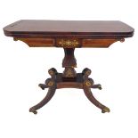 An early 19th century George IV period rosewood and brass inlaid foldover top card table: the top