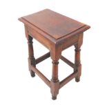 A patinated oak joint stool in 17th century style: the slightly overhanging thumbnail moulded top