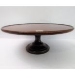 A 19th century circular dished top mahogany Lazy Susan on turned socle (50.5cm diameter)