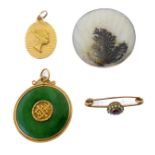 Four items: a circular jadeite disc pendant with rope-twist border and central Chinese symbol