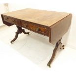 An early 19th century Regency period mahogany sofa table: crossbanded top above two true half-