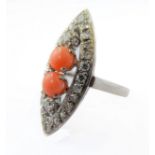 An 18-carat gold marquise shape ring set with coral and diamonds, ring size K