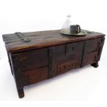 A patinated and iron-mounted miniature reproduction oak chest in early style: the lid with strap