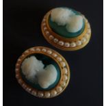 A pair of hardstone cameo and half pearl ear clips: each containing a green agate with a carved