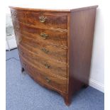 A large early 19th century bow-fronted mahogany chest: flame mahogany veneered top above two half-