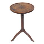 An 18th century circular-topped oak occasional table of vernacular construction: galleried top of