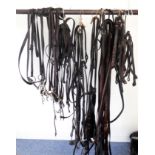 A quantity of leather tack comprising 4 part bridles (7” loose ring snaffle; Pelham 6”; Pelham