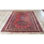 A 20th century Persian Shiraz: red ground with three central medallions within darker floral