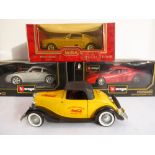 Four diecast model cars: a Burago Ferrari Testarossa (1984); a Burago Porsche Carrera (1993); a