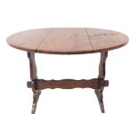 A small oval, twist-top occasional oak table of good colour (66cm wide leaves up x 44cm high)