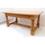 A fine Arts & Crafts style oak dining table: pollarded-style planked top above friezes with