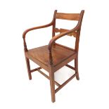 An early 19th century mahogany open armchair on square tapering legs