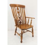 A modern lathe-back open-armed chair in 19th style: pierced splat, shaped seat, turned splaying legs