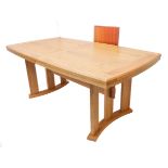 A good, large, modern extending oak dining table on vertical supports locating into concave