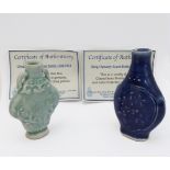 Two Chinese Qing dynasty porcelain scent bottles, each with plain glaze over raised floral