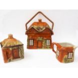 A 1930s three-piece hand-painted cottage ware service by Price of Kensington: biscuit barrel and