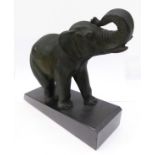 A spelter model of an elephant on a marble base (20cm long x 20cm high x 7cm wide)