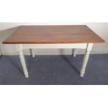 A modern kitchen-style table: stained pine top above a white painted base and turned tapering