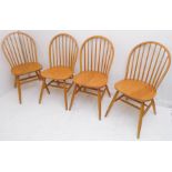 A set of four modern comb-back style chairs