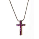 A hallmarked silver pendant modelled as a crucifix inlaid with hand-cut pink stones (possibly pink