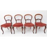 A set of four mid-19th century walnut balloon-back chairs: overstuffed seats and moulded cabriole-