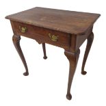 An 18th century oak lowboy: the moulded overhanging top above a single full-width drawer, raised