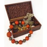 A collection of costume jewellery within a brown textured leather jewellery box. To include
