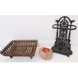 A small late 19th century cast-iron stick-stand, an iron fire-grate and a hand-hewn rock / stone