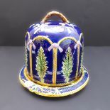 A large and ornate Victorian majolica Stilton cheese dish and cover, JRL stamp on base, chips to