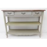 A shabby-chic-style dresser / side-table: three drawers and conforming undertier stretchers below;