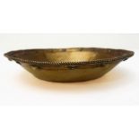 A hallmarked silver-gilt bowl: the border decorated with small crosses and spheres in low relief,