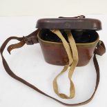 An early 20th century pair of military-style field glasses within brass-bound patinated hand-