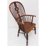 A mid-19th century comb-back Windsor armchair: yew wood bows and ornately pierced splat (with