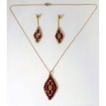 A high grade gold and ruby necklace with matching earrings