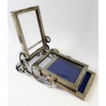 An unusual hallmarked silver triple photograph frame. Each frame hinged and falling forward to