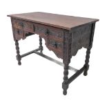 An early 20th century oak side table: two half width drawers with period style iron handles above