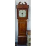 A 19th century thirty-hour oak longcase clock: the broken swan-neck pediment above a glazed hood