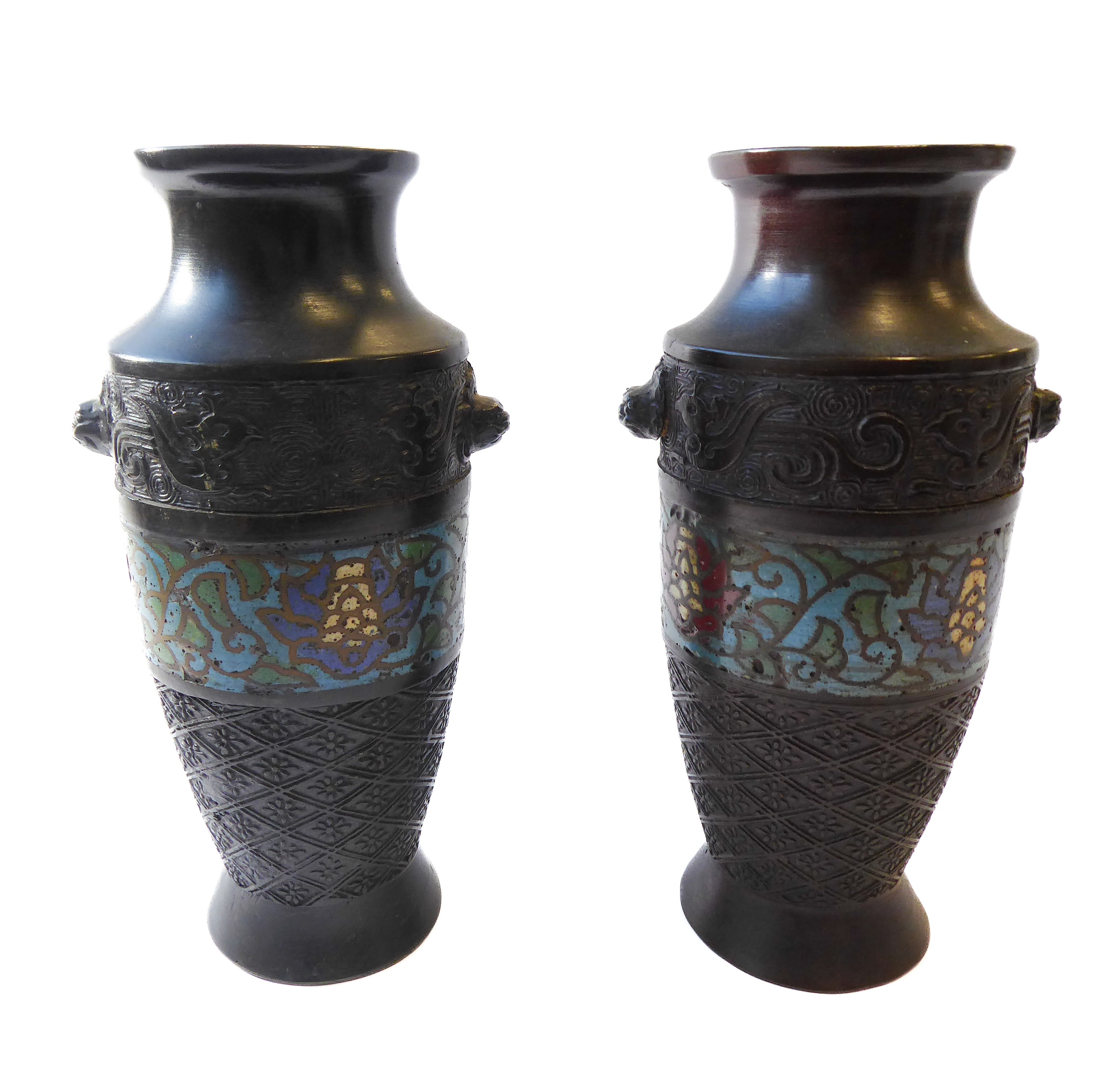 A pair of early 20th century Japanese metal vases decorated with a central cloisonné scrolling
