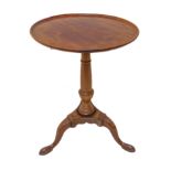 A 19th century circular mahogany tilt-top occasional table: gun-barrel turned stem; three