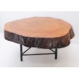 An unusual occasional table formed from a section cut from a mature tree trunk: good colour and