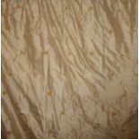 A pair of gold heavy silk curtains with embroidered floral motifs embellished with velvet and