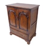 A good reproduction solid oak side cabinet: the two Moorish-style fielded panel doors opening to