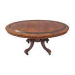 A 19th century oval walnut and banded coffee/occasional table on four carved, downswept legs